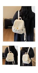 Close-up of cream canvas backpack with flap cover and yellow button detail for students