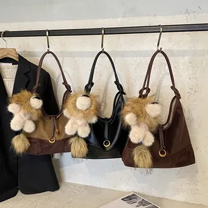Three minimalist frosted tote bags with lion plush charms and elegant metal ring accents