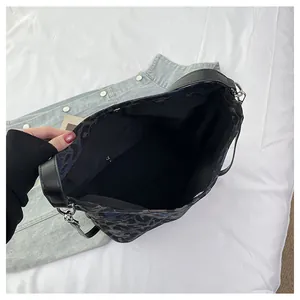Interior view of leopard print bucket bag showing main compartment and zipper pocket