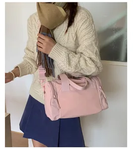 Detail of pink nylon duffel bag with adjustable strap and smooth texture