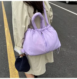 Close-up of lilac quilted tote bag with drawstring detail and puffed nylon texture