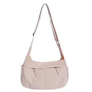 Minimalist peach pink nylon crossbody moon bag with adjustable strap for daily use