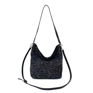 Large leopard print bucket bag with adjustable straps for shoulder and crossbody carry