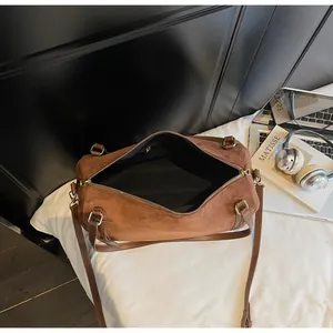 Detailed top view of the brown suede Boston bag showing spacious black interior lining