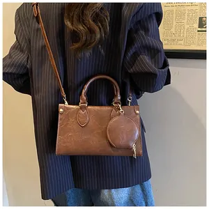 Brown retro PU leather square handbag with round coin purse on striped suit model