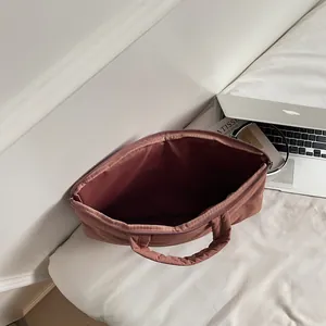 Modern quilted down tote bag for women in pink featuring a soft padded laptop compartment