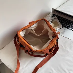 Orange quilted nylon large tote bag with adjustable shoulder strap and spacious interior