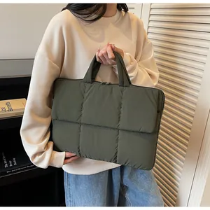 Detail of green quilted puffer laptop bag showing soft texture and high-quality stitching