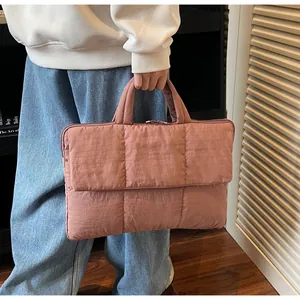 Detail showing dusty pink quilted nylon fabric and soft padded front flap design