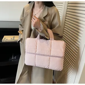 Quilted light pink laptop tote bag with square stitching and elegant dual handles