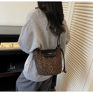 Detail of leopard print bucket bag with leather flap and MUONJI&BAGS brand inscription