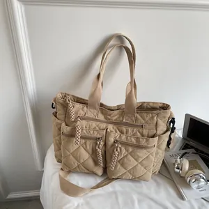 Khaki quilted nylon tote bag with multiple pockets for daily commuting and travel