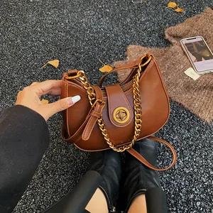 Retro caramel crescent moon bag with golden chain and sleek leather for autumn style