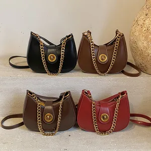 Chic crescent-shaped chain crossbody bags in four colors on an artistic stone background