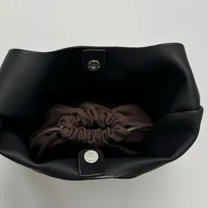 Black large capacity tote bag with brown drawstring insert and magnetic closure