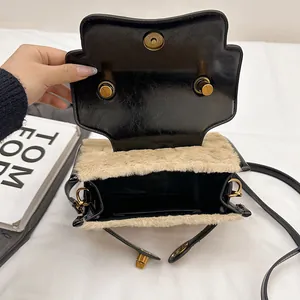 Fashionable faux fur and black leather patchwork handbag with gold magnetic closure