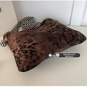 Detail of leopard print tote bag with reinforced bottom and striped rope shoulder strap