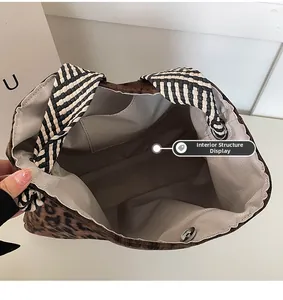 Detail view of leopard print tote bag interior with inner pocket and magnetic closure