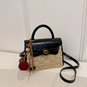 Minimalist square crossbody bag in black and beige faux fur with golden twist lock
