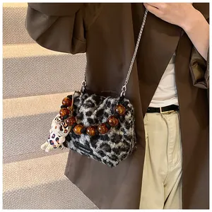 Fashionable plush leopard print shoulder bag with amber beads and silver chain detail