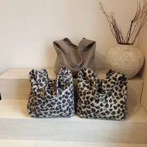 Minimalist large velvet tote bags in solid grey and leopard patterns on a minimalist stage