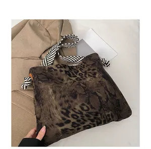 Detail of vintage leopard print tote bag with thick black and white braided shoulder strap