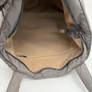 Quilted nylon tote bag with spacious interior compartment and secure zipper pocket