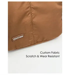 Detail of ChicCraze brown quilted tote showing durable custom fabric and stitched logo tag