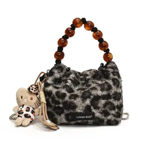 Plush leopard print handbag with amber beaded handle and stylish plush cat pendant charm