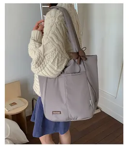 Greyish purple high-capacity tote bag with side pockets and a decorative brown bow