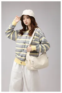 Chic beige nylon crossbody bag styled with casual knit cardigan and white trousers