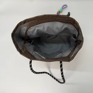 Brown checkered canvas tote bag with woven rope handles and large interior capacity
