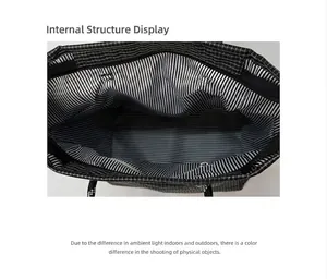 Detail view of large canvas tote bag showing striped lining and internal zipper pocket