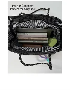 Macro view of checkered tote bag interior with large capacity for laptop and books