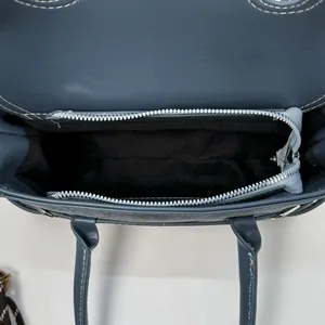 Top view of deep blue shoulder bag interior showing spacious compartments and zipper pocket