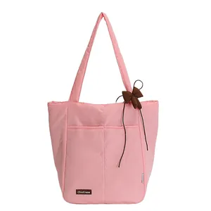 Pink minimalist nylon tote bag with brown ribbon bow and ChicCraze leather patch logo