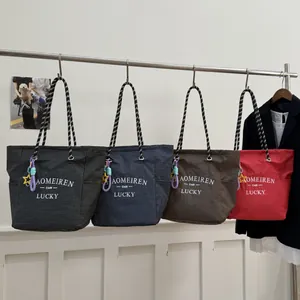 Minimalist canvas tote bags with checkered pattern and braided rope handles in four colors