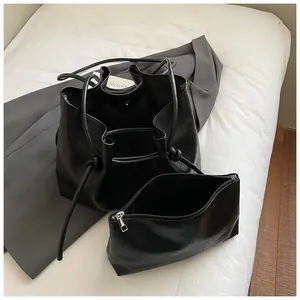 Large black faux leather tote bag and zipper pouch set with drawstring shoulder straps