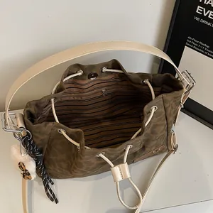 Deep brown retro bucket bag with striped interior lining and leopard plush charm