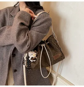 Brown leopard print bucket bag featuring drawstring closure and cute character pendant