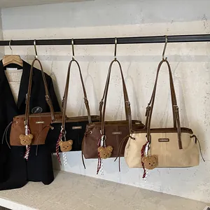 Fashionable suede tote bag in four colors with bear pendant and shoulder straps