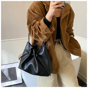 Detail of knotted shoulder strap on a black soft leather tote bag for women