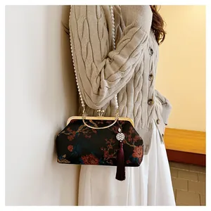 Detail of red peony embroidery on vintage brocade handbag with a pearl strap and tassel