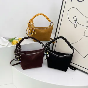 Minimalist matte suede crossbody bags with braided handles and tassel decor in three colors