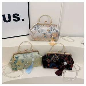 Detailed embroidery of bamboo and floral patterns on vintage silk evening purses