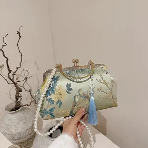Elegant mint silk qipao handbag with floral embroidery and pearl strap for evening events