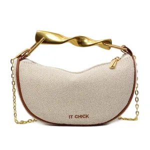 Minimalist off-white canvas dumpling bag with gold twist handle and chain strap