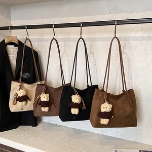 Retro suede hobo bags with hollow flower pattern and bear charm in four chic colors
