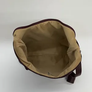 Minimalist large burgundy tote bag with spacious interior and zipper closure for women