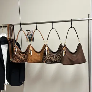 Retro hobo shoulder bags in leopard print and suede finishes with beaded tassel charms